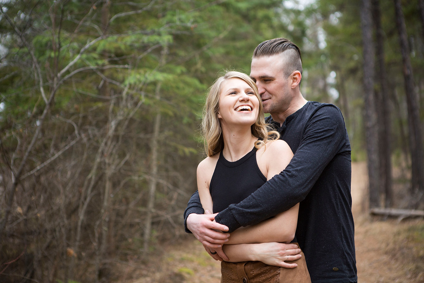 A couple embraces during their portrait session in Prince Albert, documented by photographer UBU Photos.