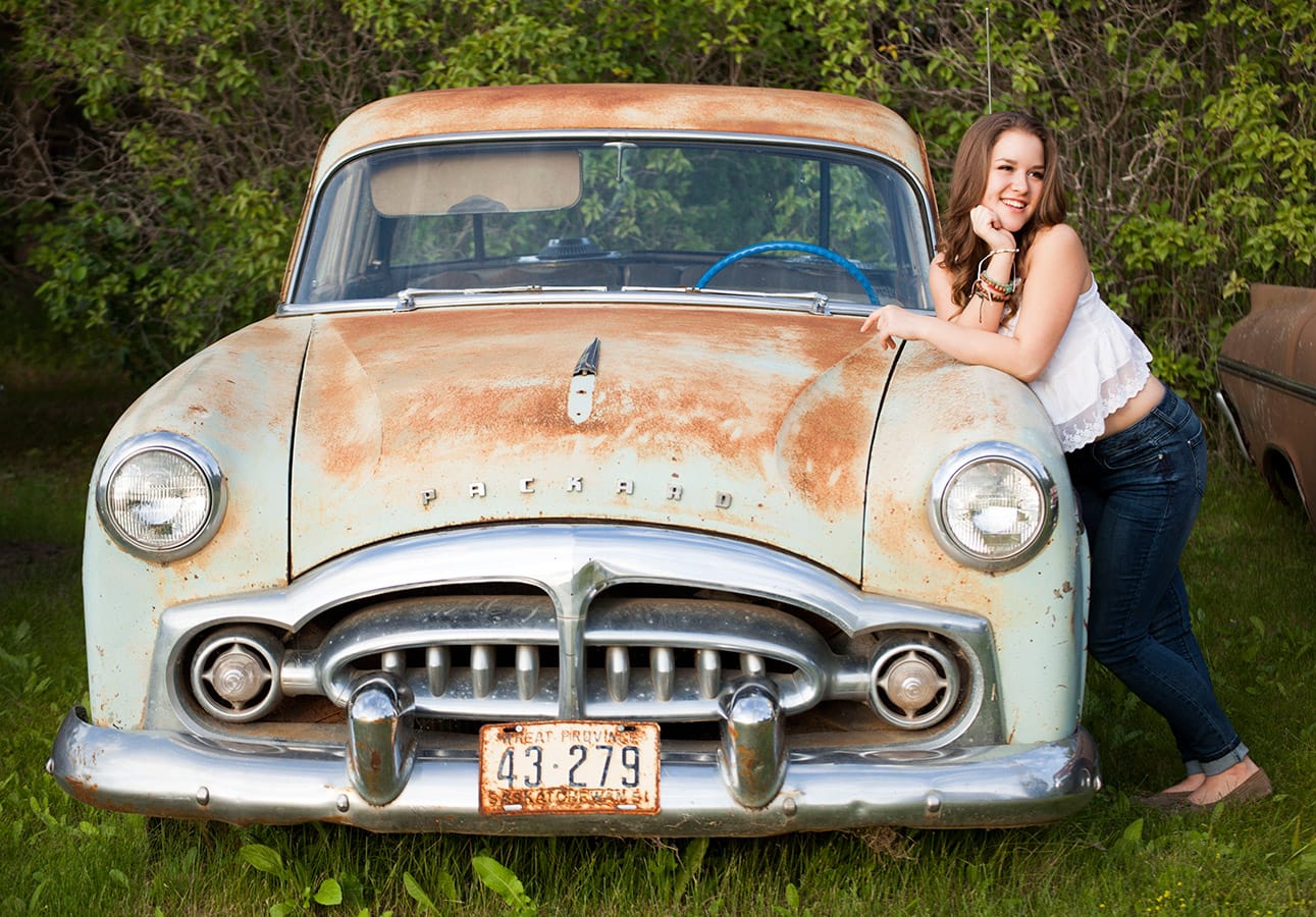 personal lifestyle photography portrait in Prince Albert, a model stands by a vintage car