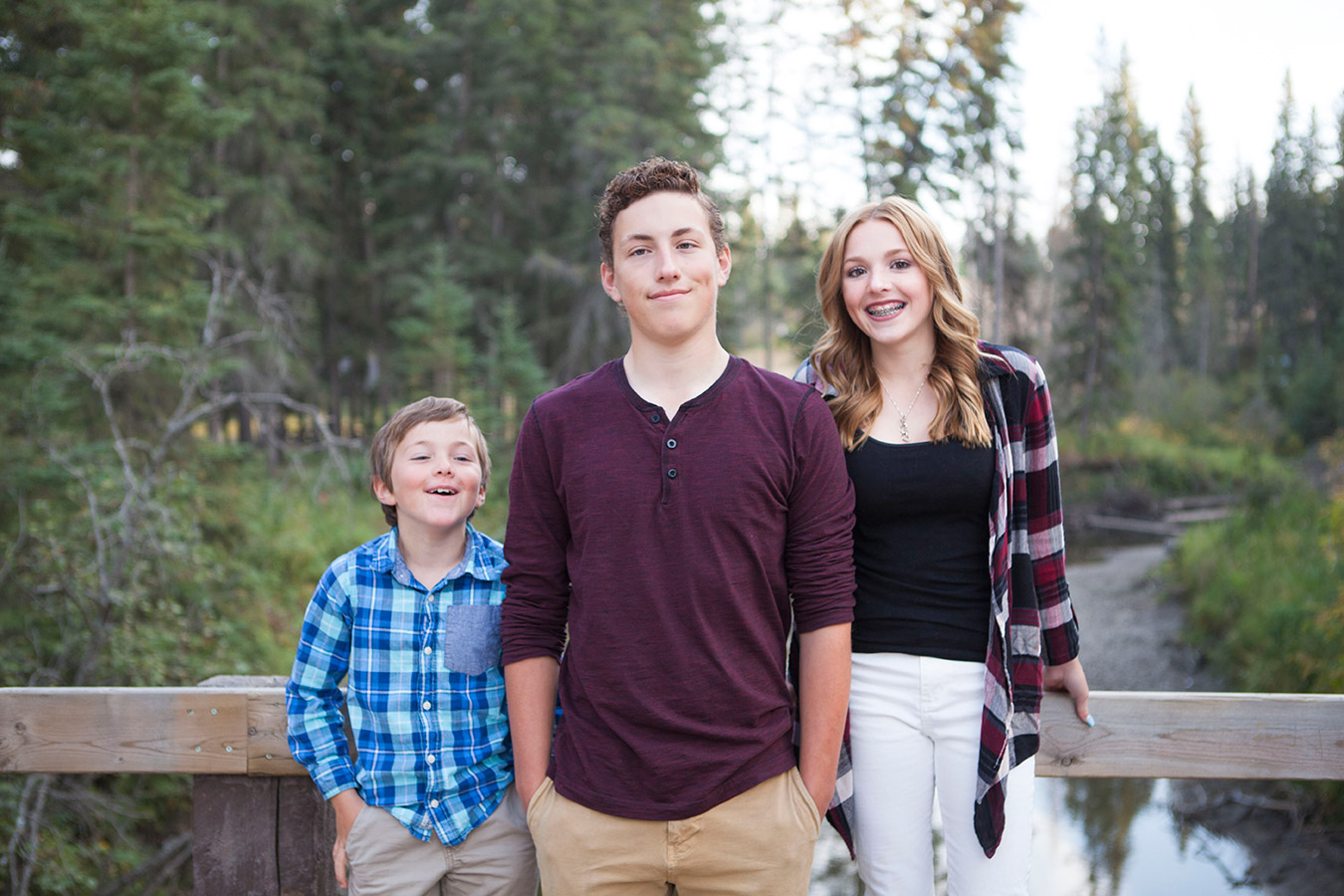 Prince Albert family photographer UBU Photos, captures a family posing on a bridge