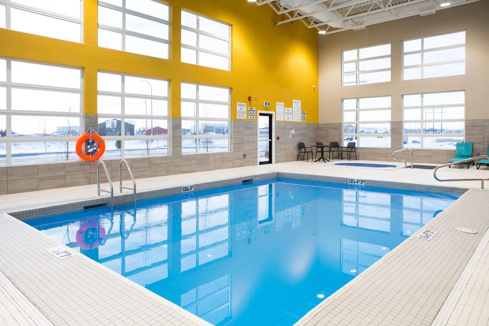 Light shines in the pool windows at holiday inn in Prince Albert, Saskatchewan, during a commercial photography shoot by UBU Photos 
