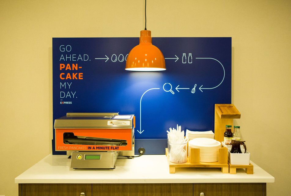 A lamp lights a food station during still life corporate photography in prince albert